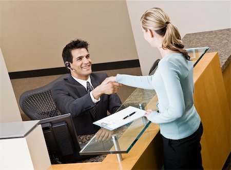simsearch:400-04167547,k - Businesswoman shaking hands with receptionist.  Horizontally framed shot. Stock Photo - Budget Royalty-Free & Subscription, Code: 400-04167447