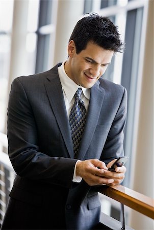 simsearch:400-04167547,k - Young businessman texting.  Vertically framed shot. Stock Photo - Budget Royalty-Free & Subscription, Code: 400-04167477