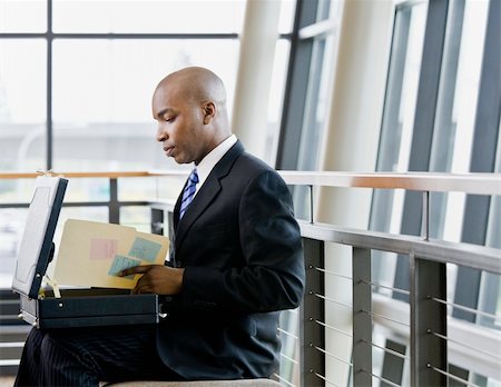 simsearch:400-04167566,k - Young businessman with briefcase looking at folder.  Horizontally framed shot. Stockbilder - Microstock & Abonnement, Bildnummer: 400-04167472