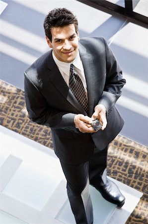 simsearch:400-04167547,k - Man in business suit texting.  Vertically framed shot. Stock Photo - Budget Royalty-Free & Subscription, Code: 400-04167481