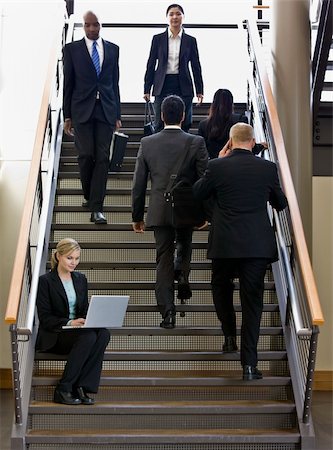 Businesswoman sitting on busy stairs with laptop.  Vertically framed shot. Stock Photo - Budget Royalty-Free & Subscription, Code: 400-04167498