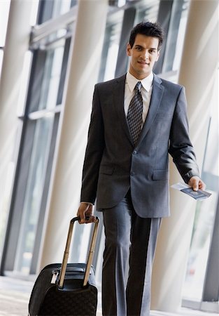 simsearch:400-04167547,k - Young businessman with passport and luggage.  Vertically framed shot. Stock Photo - Budget Royalty-Free & Subscription, Code: 400-04167492