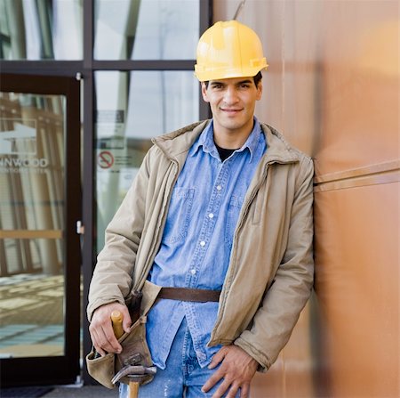 simsearch:400-04167547,k - Young male construction worker with yellow hard hat leaning on wall.  Square framed shot. Stock Photo - Budget Royalty-Free & Subscription, Code: 400-04167519