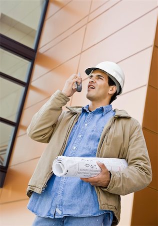 simsearch:400-04167547,k - Young male construction worker with white hard hat using radio.  Vertically framed shot. Stock Photo - Budget Royalty-Free & Subscription, Code: 400-04167522