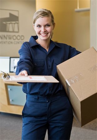 simsearch:400-04167547,k - Young woman delivering box holding delivery receipt form.  Vertically framed shot. Stock Photo - Budget Royalty-Free & Subscription, Code: 400-04167545