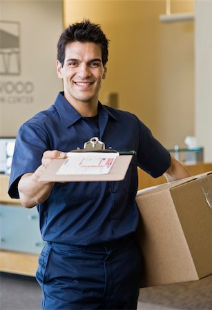 simsearch:400-04167547,k - Young man delivering box holding delivery receipt form.  Vertically framed shot. Stock Photo - Budget Royalty-Free & Subscription, Code: 400-04167546