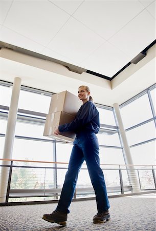 simsearch:400-04167547,k - Young woman delivering boxes.  Vertically framed shot. Stock Photo - Budget Royalty-Free & Subscription, Code: 400-04167549