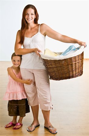 Mother holding laundry basket with daughter near Stock Photo - Budget Royalty-Free & Subscription, Code: 400-04167673