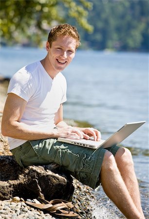 simsearch:400-04168729,k - Man using laptop near stream Stock Photo - Budget Royalty-Free & Subscription, Code: 400-04167787