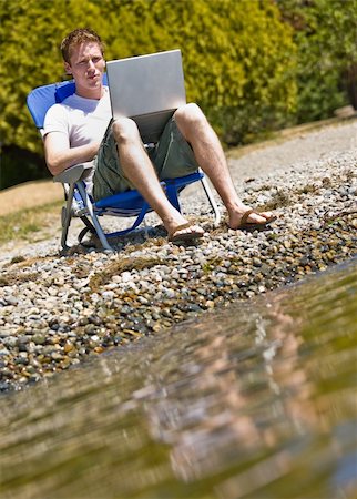 simsearch:400-04168729,k - Man using laptop near stream Stock Photo - Budget Royalty-Free & Subscription, Code: 400-04167791