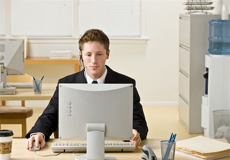 simsearch:400-04129016,k - Businessman in headset working at computer Stock Photo - Budget Royalty-Free & Subscription, Code: 400-04167816