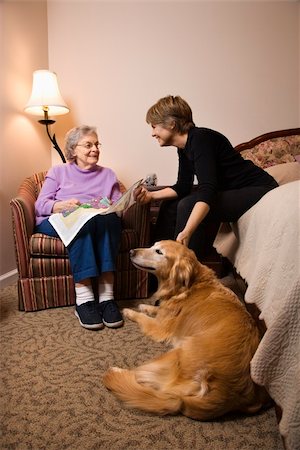 Elderly Woman in her bedroom does needlepoint with a younger woman and a dog in the room. Vertical shot. Stock Photo - Budget Royalty-Free & Subscription, Code: 400-04167947