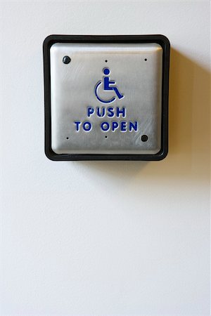 pushing door - Handicapped access entrance pad mounted to a wall.  Vertical shot. Stock Photo - Budget Royalty-Free & Subscription, Code: 400-04167957