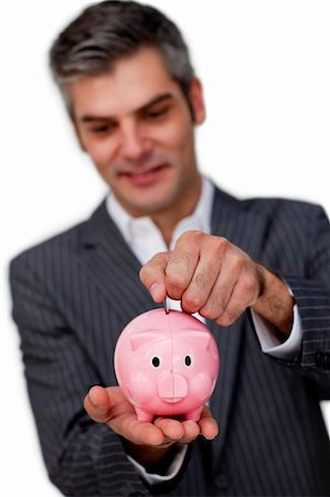 simsearch:400-05715051,k - Sophisticated male executive saving money in a piggybank against a white background Fotografie stock - Microstock e Abbonamento, Codice: 400-04168034