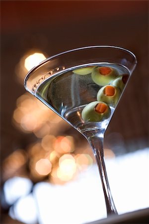 Martini glass seen from below with the olives being reflected off of the top of the drink. Vertical shot. Stock Photo - Budget Royalty-Free & Subscription, Code: 400-04168232