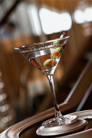 Martini glass sitting on the bottom of a banister railing. Vertical shot. Stock Photo - Budget Royalty-Free & Subscription, Code: 400-04168233