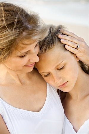 parent comforting teen - Daughter rests her head on her mother's shoulder at the beach. Vertical shot. Stock Photo - Budget Royalty-Free & Subscription, Code: 400-04168315