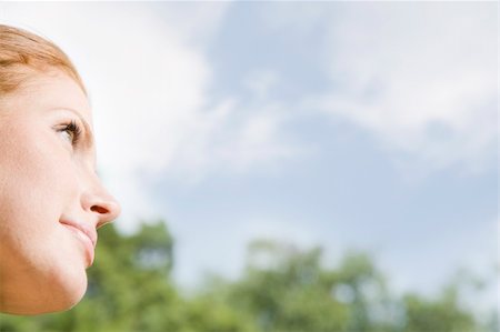 simsearch:633-08150899,k - Close-up cropped profile of a young woman outdoors. She is looking away from the camera, and only her face is viewable. Horizontally framed shot. Stock Photo - Budget Royalty-Free & Subscription, Code: 400-04168367