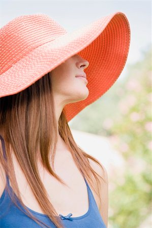 simsearch:6108-05867864,k - Image of young woman outdoors, wearing a hat. She is looking away from the camera and head and shoulders are viewable. Vertically framed shot. Stockbilder - Microstock & Abonnement, Bildnummer: 400-04168371