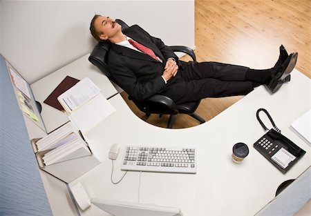 Businessman sleeping at desk with feet up Stock Photo - Budget Royalty-Free & Subscription, Code: 400-04168502