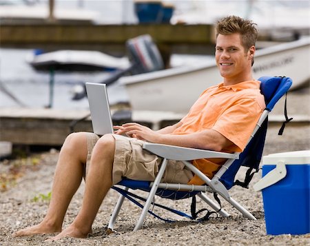 Man using laptop on beach Stock Photo - Budget Royalty-Free & Subscription, Code: 400-04168560