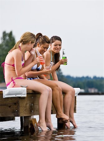 simsearch:400-04168680,k - Friends sitting on pier at lake drinking soda Foto de stock - Super Valor sin royalties y Suscripción, Código: 400-04168608