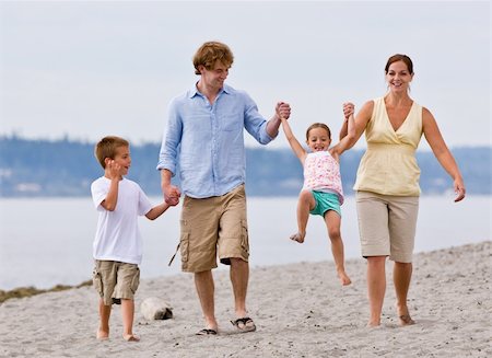 dad swinging kids at beach - Family playing at beach Stock Photo - Budget Royalty-Free & Subscription, Code: 400-04168651