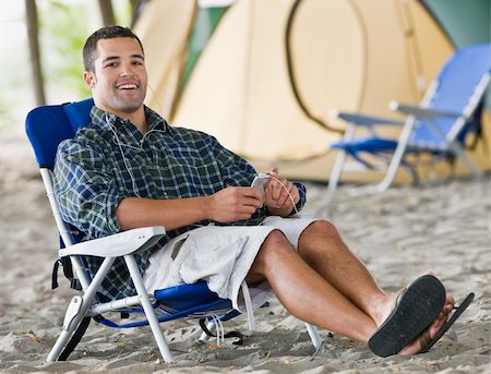 simsearch:400-04168729,k - Man using mp3 player at campsite Stock Photo - Budget Royalty-Free & Subscription, Code: 400-04168696