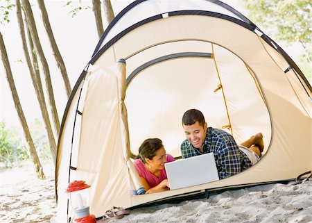 simsearch:400-04168729,k - Couple laying in tent using laptop Stock Photo - Budget Royalty-Free & Subscription, Code: 400-04168706