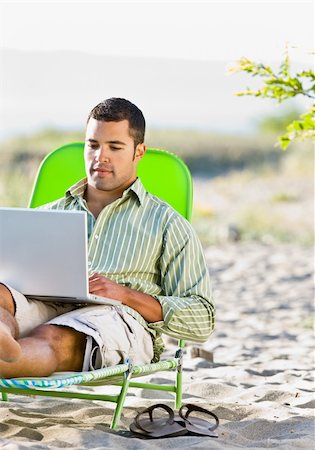 Man using laptop at beach Stock Photo - Budget Royalty-Free & Subscription, Code: 400-04168728