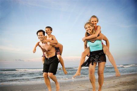 piggyback daughter at beach - Mother and father give their children piggy back rides at the beach. Horizontal shot. Stock Photo - Budget Royalty-Free & Subscription, Code: 400-04168787