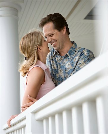 Affectionate couple face one another on a house porch. Vertical shot. Stock Photo - Budget Royalty-Free & Subscription, Code: 400-04168796