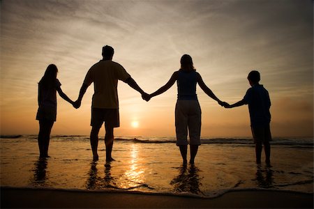 Silhouette of family holding hands on beach watching the sunset. Horizontally framed shot. Stock Photo - Budget Royalty-Free & Subscription, Code: 400-04168817
