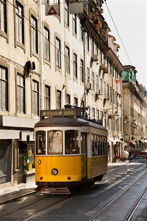 streetcar track - Streetcar running down the middle of the street in Lisbon, Portugal. Vertical shot. Stock Photo - Budget Royalty-Free & Subscription, Code: 400-04168921