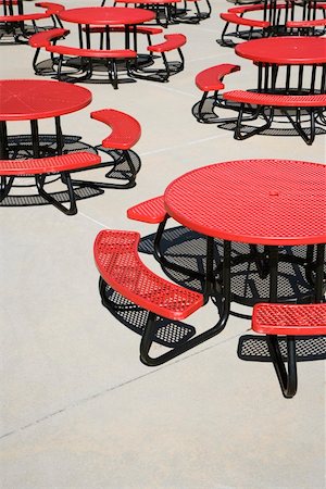 Red metal circular cafeteria tables on an outdoor patio. Vertical shot. Stock Photo - Budget Royalty-Free & Subscription, Code: 400-04169051