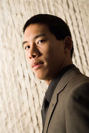 simsearch:400-04167566,k - Low angle head-and-shoulders portrait of Asian young adult businessman. Vertical format. Stockbilder - Microstock & Abonnement, Bildnummer: 400-04169178