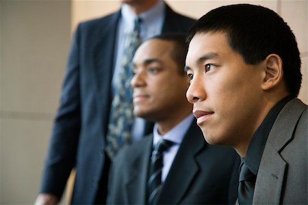 simsearch:400-04169171,k - Asian businessman in the foreground with African-American businessman and a third businessman in the background. Horizontal format. Foto de stock - Super Valor sin royalties y Suscripción, Código: 400-04169187