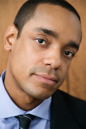 simsearch:400-04167566,k - Cropped close-up portrait of African-American mid-adult businessman. Vertical format. Stockbilder - Microstock & Abonnement, Bildnummer: 400-04169192