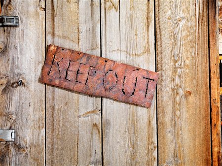 simsearch:400-03975187,k - Rusty sign reading 'KEEP OUT'. It is hanging on an old weathered wooden door. Horizontal shot. Stock Photo - Budget Royalty-Free & Subscription, Code: 400-04169373