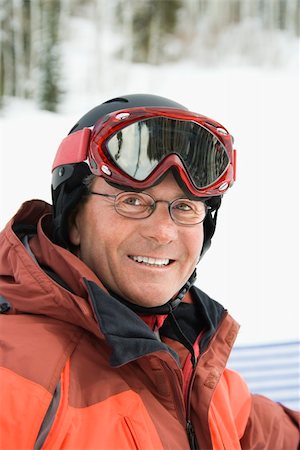 pictures of people skiing in colorado - Smiling male skier wearing red goggles and orange ski jacket. Vertical shot. Stock Photo - Budget Royalty-Free & Subscription, Code: 400-04169425