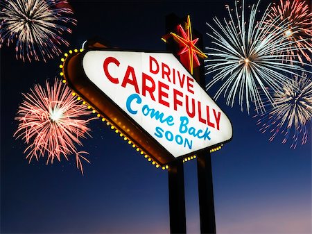 Las Vegas sign at night reading Drive carefully and Come back soon with fireworks in background. Horizontally framed shot. Stock Photo - Budget Royalty-Free & Subscription, Code: 400-04169448
