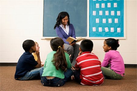 Teacher reading book to young students in classroom. Horizontally framed shot. Stock Photo - Budget Royalty-Free & Subscription, Code: 400-04169526