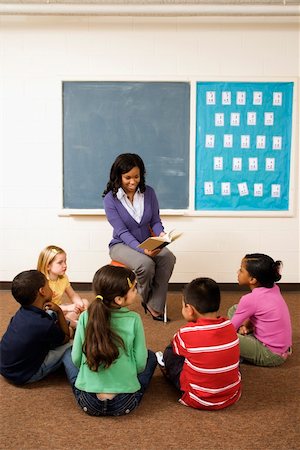 Teacher reading book to young students in classroom. Vertically framed shot. Stock Photo - Budget Royalty-Free & Subscription, Code: 400-04169527