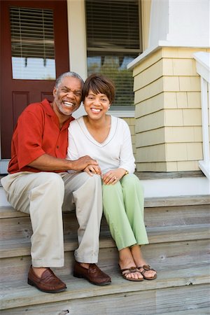 Couple sitting on outdoor steps of home smiling. Vertically framed shot. Stock Photo - Budget Royalty-Free & Subscription, Code: 400-04169585
