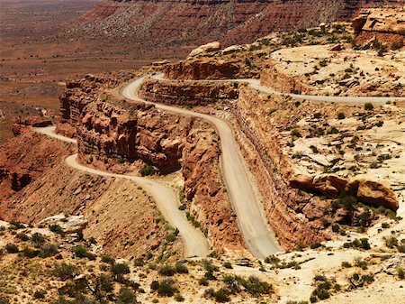 High angle view of a winding dirt road on a desert rock formation. The surrounding landscape is visible in the background. Horizontal shot. Stock Photo - Budget Royalty-Free & Subscription, Code: 400-04169612