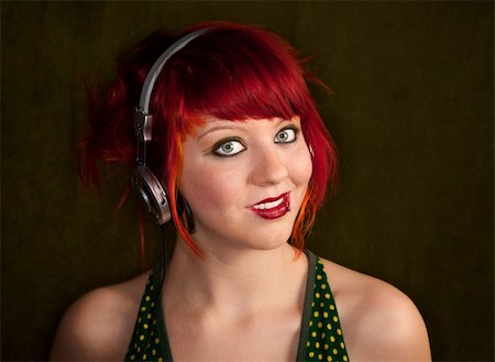 simsearch:400-06330521,k - Pretty punky girl with brightly dyed red hair listening to music Photographie de stock - Aubaine LD & Abonnement, Code: 400-04169925