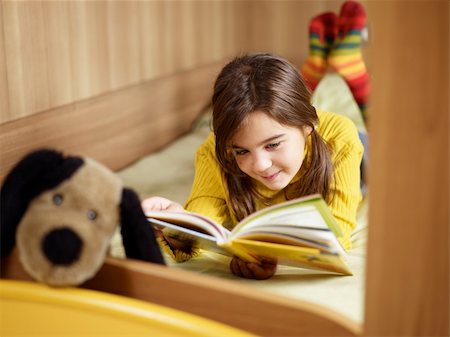 girl lying on bed and reading book. Copy space Stock Photo - Budget Royalty-Free & Subscription, Code: 400-04160520