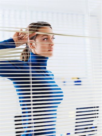 young businesswoman looking through blinds. Copy space Stock Photo - Budget Royalty-Free & Subscription, Code: 400-04160533