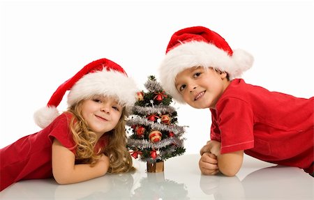 simsearch:400-04114221,k - Happy kids with santa hats and small christmas tree - isolated Stock Photo - Budget Royalty-Free & Subscription, Code: 400-04160895