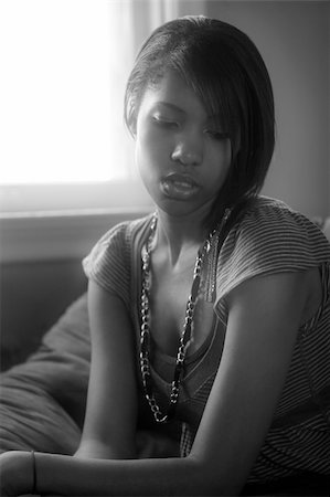 A beautiful female sitting by a window in deep thought. Stock Photo - Budget Royalty-Free & Subscription, Code: 400-04161186